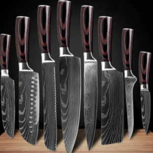 Professional chef kitchen knife set laid out on a neutral background
