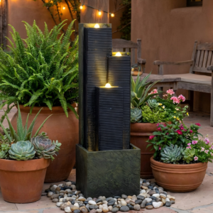 Cascading column water fountain on a patio at dusk