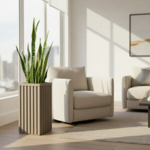 Column planter with a snake plant beside an armchair